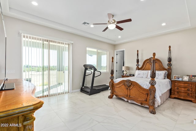 bedroom with a raised ceiling, ceiling fan, light tile floors, and access to outside