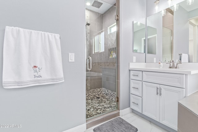 bathroom featuring a shower with door, tile floors, and vanity