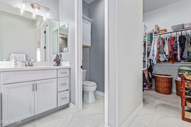 bathroom with vanity, tile floors, and toilet