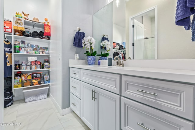 bathroom with tile flooring and vanity with extensive cabinet space