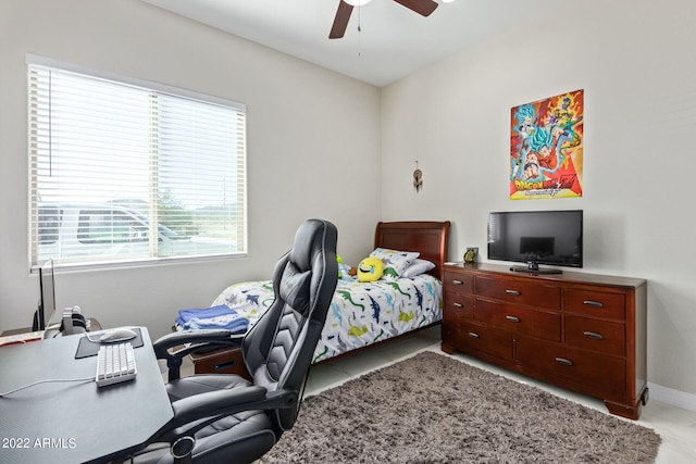 bedroom with ceiling fan and multiple windows