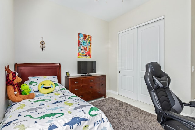 tiled bedroom with a closet