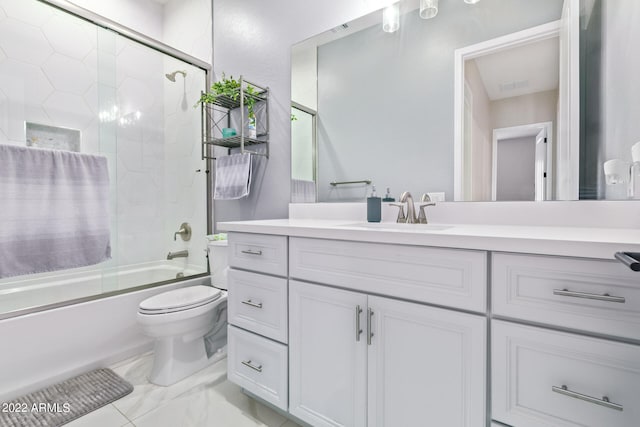 full bathroom featuring combined bath / shower with glass door, vanity with extensive cabinet space, toilet, and tile floors