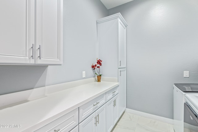 interior space featuring independent washer and dryer and tile floors