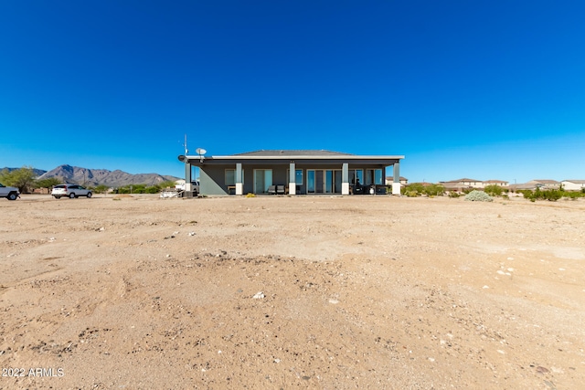 rear view of house featuring a mountain view