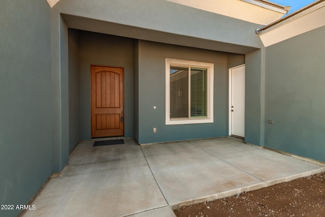 property entrance featuring a patio