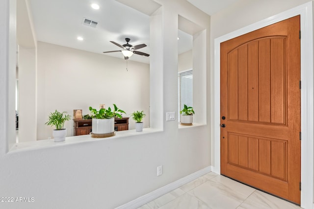 tiled entryway with ceiling fan