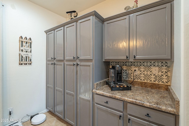 kitchen with decorative backsplash and gray cabinetry