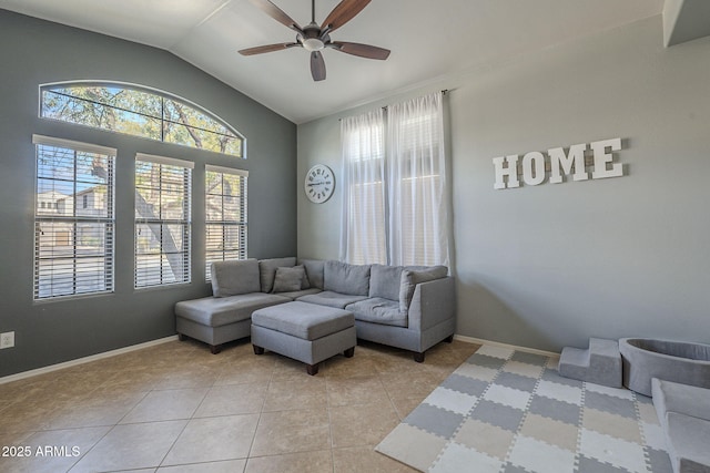 living area featuring ceiling fan, baseboards, vaulted ceiling, and light tile patterned flooring