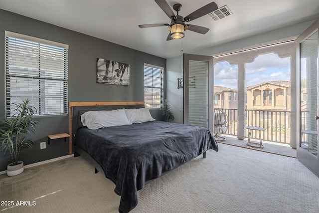 bedroom featuring carpet floors, multiple windows, visible vents, and access to exterior