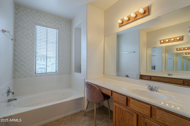 full bath with tile patterned flooring, a bath, and vanity