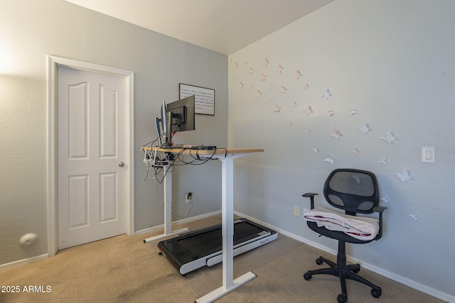 workout room featuring light carpet and baseboards