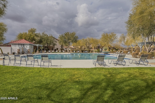 pool with a yard, a patio area, and fence