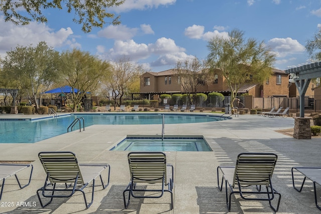 pool featuring a community hot tub, a patio area, and fence