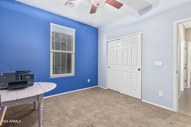 carpeted home office with ceiling fan