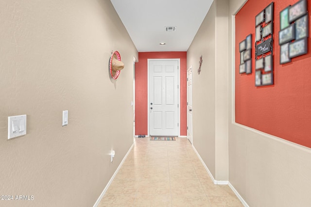 hall featuring light tile patterned flooring