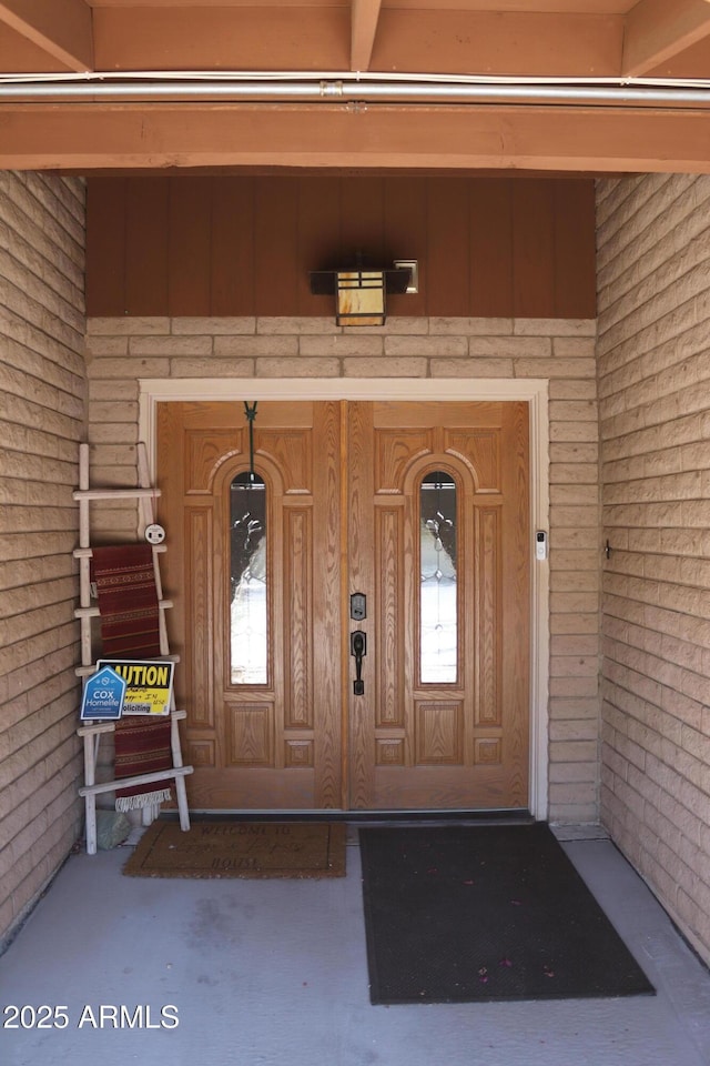 doorway to property with board and batten siding and covered porch