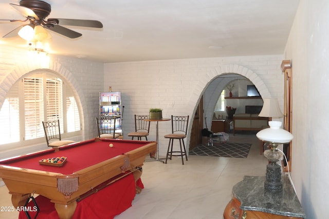 recreation room with brick wall, tile patterned floors, billiards, and ceiling fan