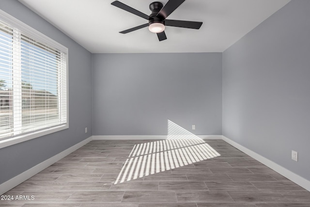 spare room with ceiling fan and hardwood / wood-style flooring