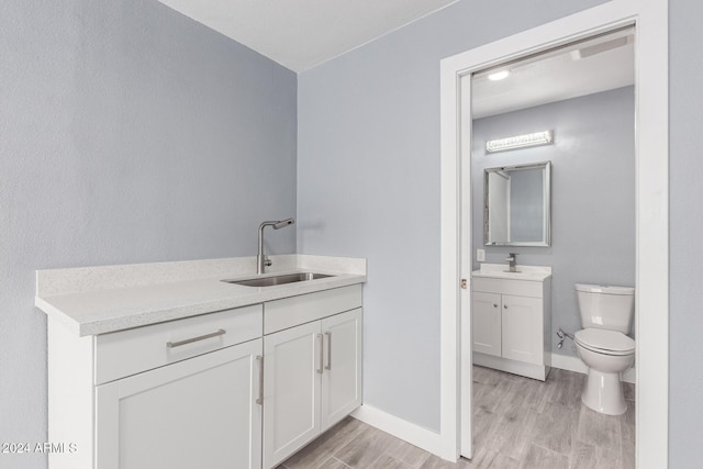 bathroom with vanity, hardwood / wood-style flooring, and toilet