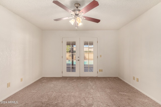 spare room featuring carpet flooring, ceiling fan, a textured ceiling, and french doors