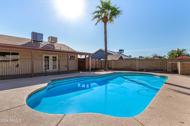 view of pool with a patio area and central AC unit