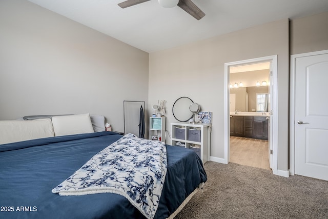 bedroom featuring carpet flooring, ceiling fan, and ensuite bathroom