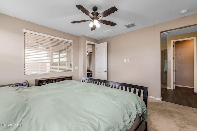 bedroom with visible vents, baseboards, ceiling fan, and carpet flooring