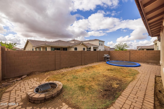 view of yard featuring a patio area, a fire pit, and a fenced backyard