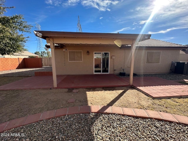 back of property with cooling unit and a patio