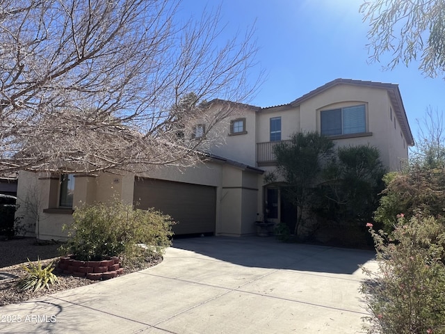 4939 W Harwell Rd, Laveen, AZ 85339 - view of front of home with concrete driveway, an attached garage, and stucco siding