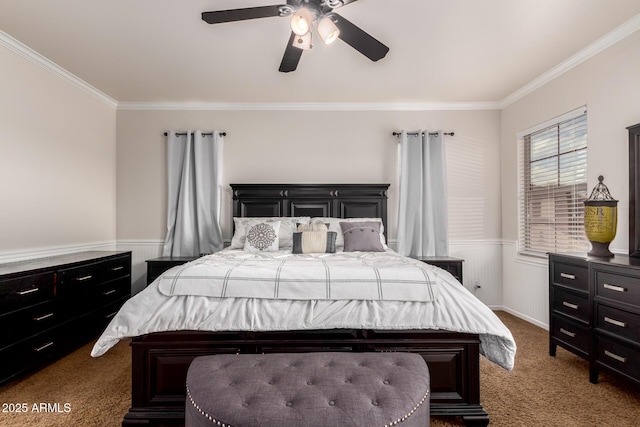 carpeted bedroom featuring a wainscoted wall, ceiling fan, and ornamental molding