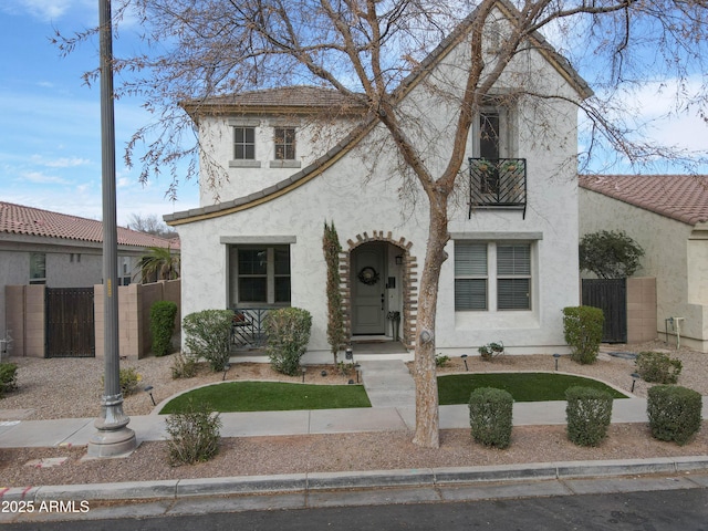 view of front of house featuring covered porch, fence, and stucco siding