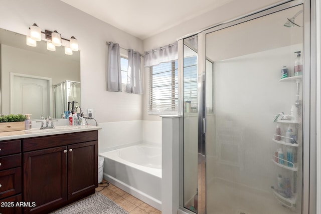 bathroom featuring a stall shower, tile patterned flooring, a bath, and vanity