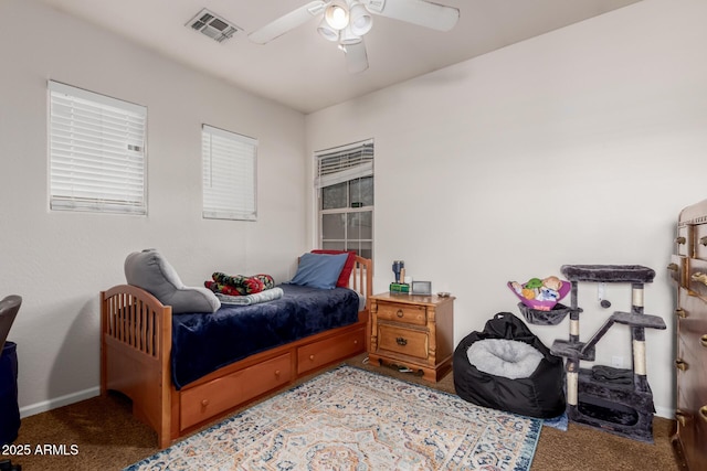 carpeted bedroom with baseboards, visible vents, and ceiling fan