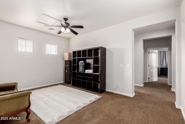 sitting room with carpet floors, a ceiling fan, and baseboards