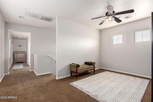 living area featuring carpet, baseboards, visible vents, and an upstairs landing