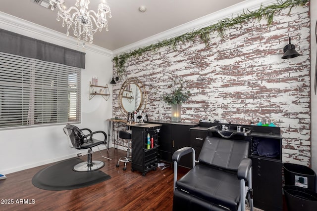 interior space featuring a chandelier, crown molding, baseboards, and wood finished floors