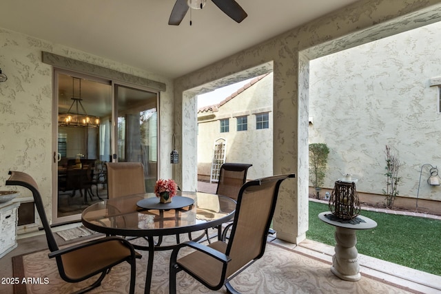 sunroom / solarium featuring a ceiling fan