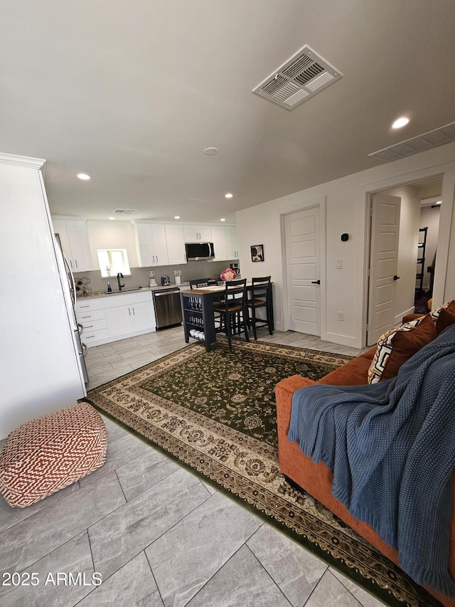 living room with visible vents and recessed lighting