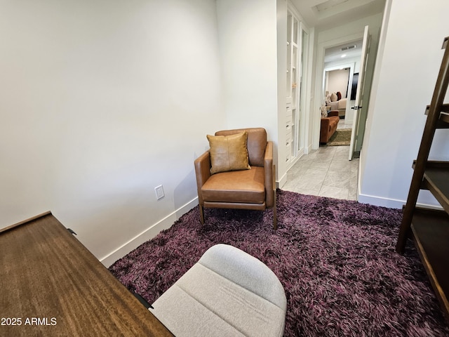 sitting room with carpet floors and baseboards