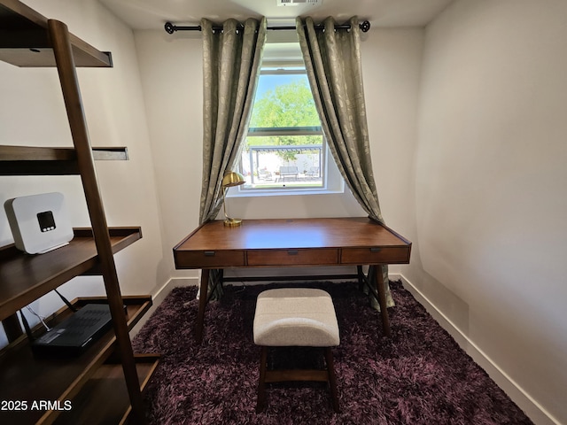 office area featuring baseboards and carpet flooring