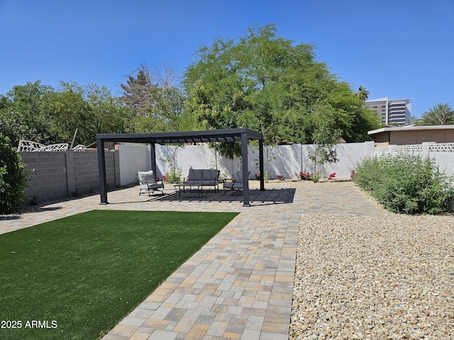 view of yard featuring a patio, a fenced backyard, and an outdoor hangout area