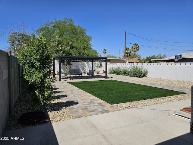 view of yard with a gazebo, an outdoor living space, a fenced backyard, and a patio area