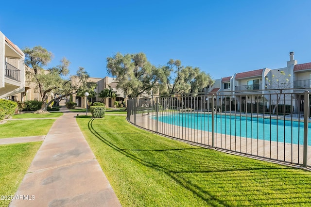 view of pool featuring a yard