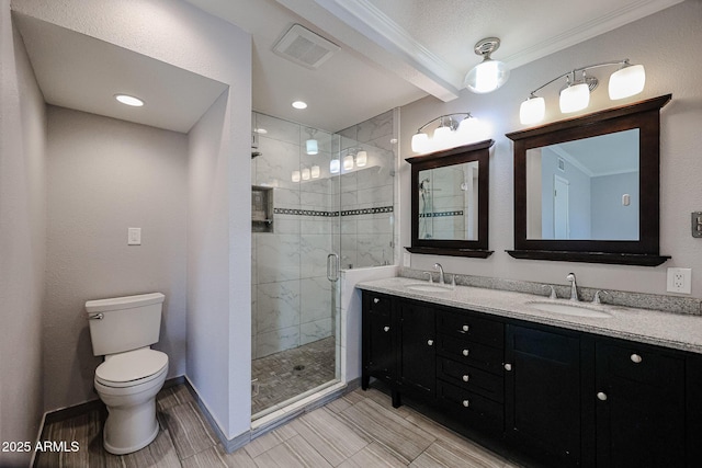 bathroom featuring toilet, vanity, a shower with door, and ornamental molding