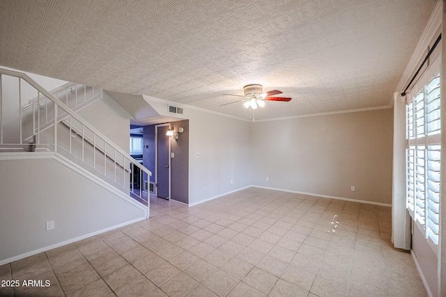 empty room featuring ceiling fan, light tile patterned flooring, crown molding, and a textured ceiling