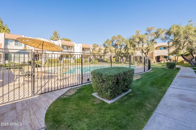 view of property's community with a pool and a yard