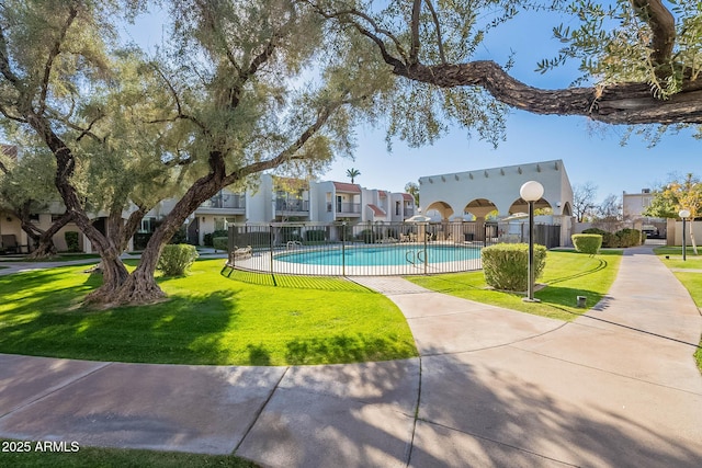 view of swimming pool featuring a yard