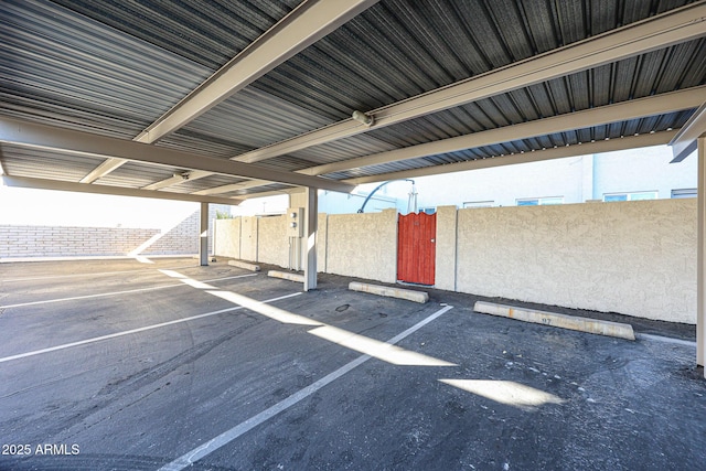 view of parking / parking lot featuring a carport